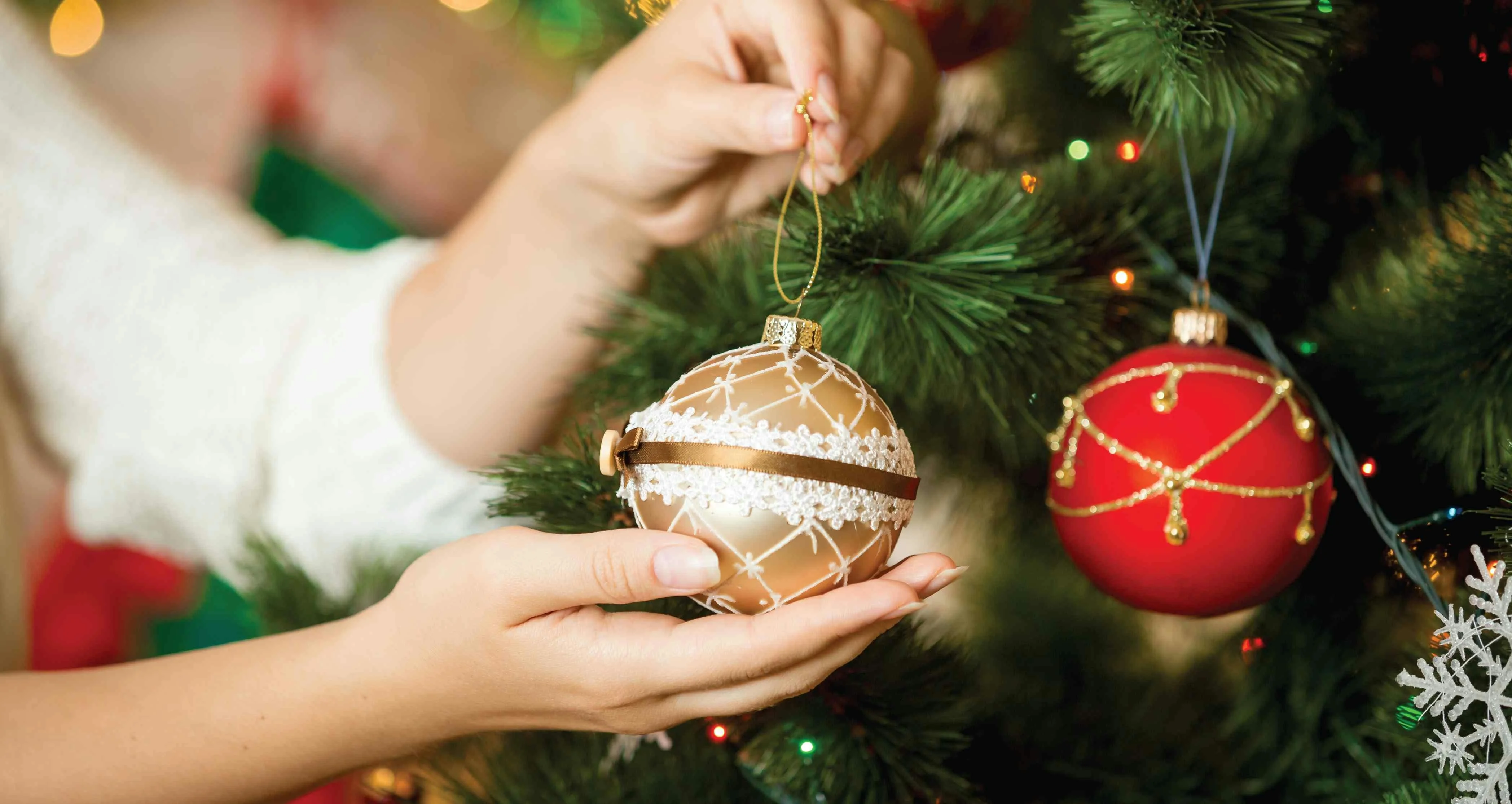 Adding decorations to an artificial christmas tree